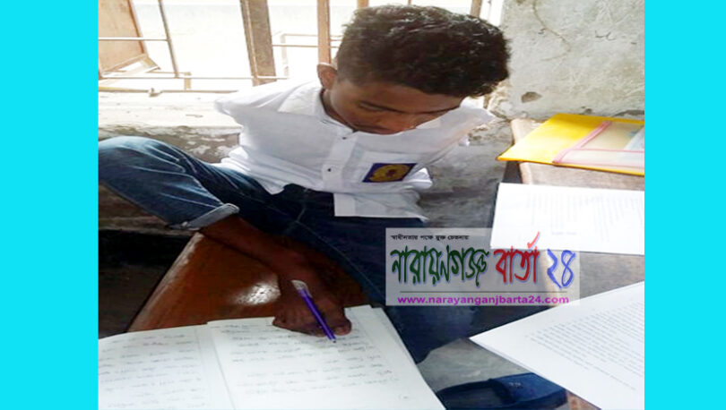 পা দিয়ে লিখে জেএসসি পরীক্ষা দিচ্ছে সঞ্জু দাস